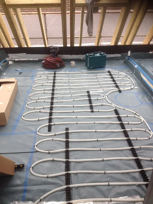 Wet underfloor heating pipework installation in progress